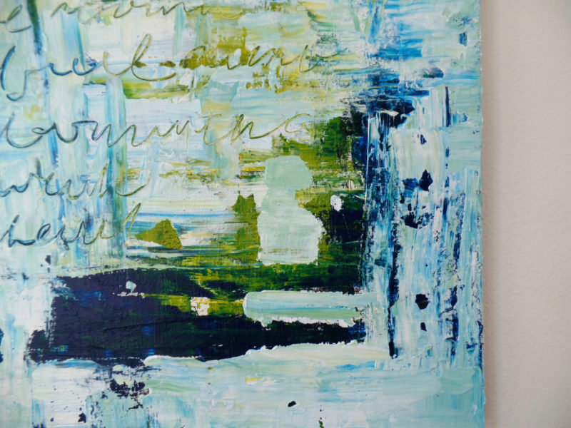 close up of abstract painting in blue by messy bed studio