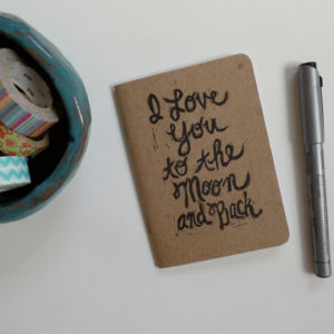 notebook printed with I love you to the moon and back with pen and washi tape
