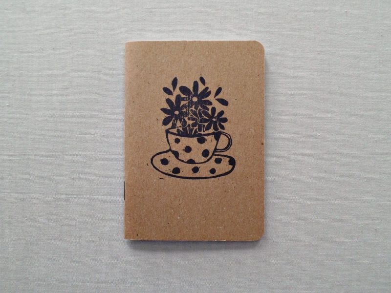 pocket notebook with polka dot tea cup and flowers in black ink