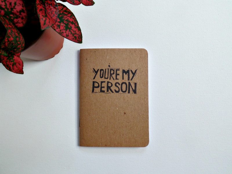 grey's anatomy you're my person quote printed on a notebook