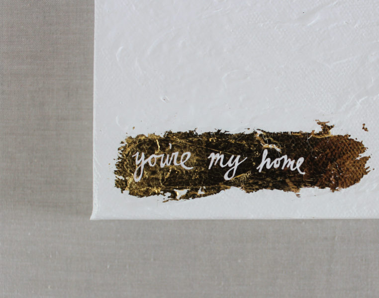 close up of white and gold leaf painting with you're my home