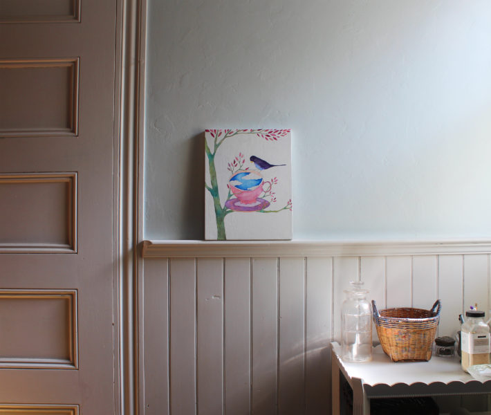 bird and teacup painting on wall ledge