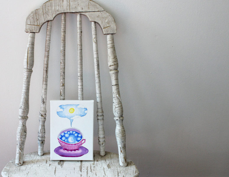 teacup full of sky original painting resting on a chair