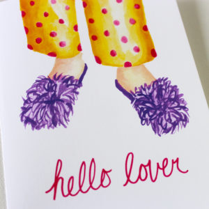 close up of funny love card with the words hello lover in pink and watercolor image of purple fuzzy slippers and polka dot pjs