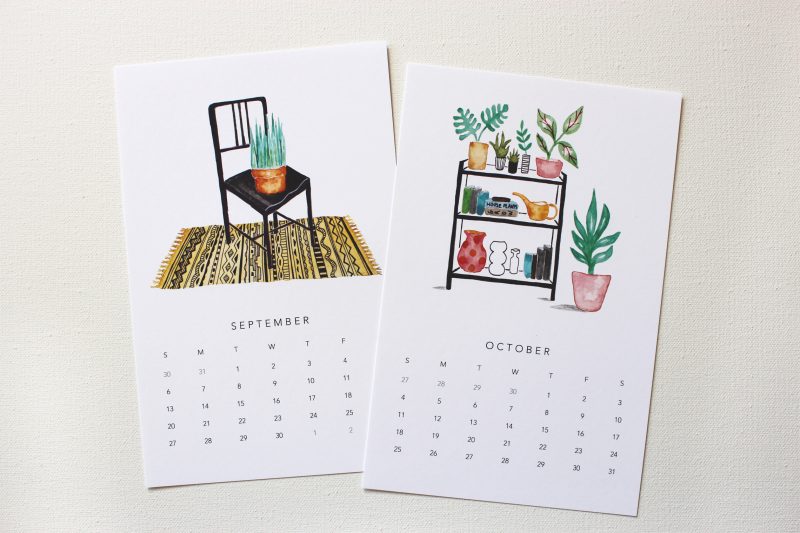 September and October of the 2020 happy houseplants calendar with watercolors of a plants on a black chair with a patterned yellow and black rug and a shelf with plants and books by messy bed studio