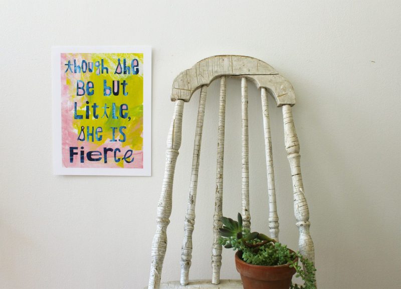 though she be but little she is fierce wall art hanging on a wall next to a vintage chair with a succulent plant on it by messy bed studio