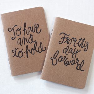 hand printed pair of wedding vow books with the words to have and to hold from this day forward in black ink by messy bed studio