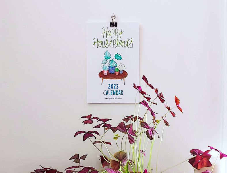 Houseplants calendar 2023 hanging on shown with a plant